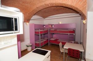 a small room with a small table and a microwave at H2O Hostel in Ljubljana