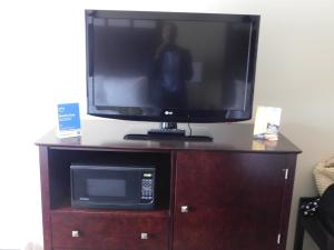 a television on top of a wooden entertainment center at Comfort Inn in Saint Clairsville