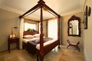 a bedroom with a canopy bed and a mirror at The Town House - Adults Only in Marbella