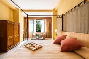 a bedroom with a large bed with a tray on it at Intelier Airén in Alcázar de San Juan +55 photos