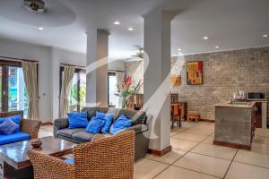 a living room with a couch and a table at Vila Ultima Bali in Seminyak