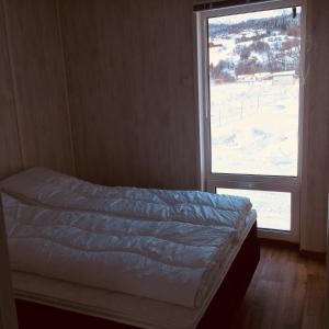 מיטה או מיטות בחדר ב-Mjøsvang Kafe