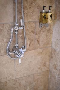 a shower in a bathroom with a soap dispenser at Woodleighton Cottages in Uttoxeter +150 photos