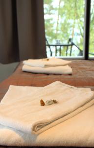two white towels sitting on top of a wooden table at Hotelli Salpa in Luumäki