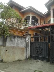 a house with a gate and a balcony at Colombo 20 minutes by train in Wattala