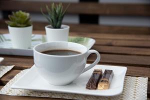 a cup of coffee on a plate on a table at Studio Apartman Ždral in Daruvar