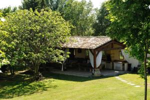 a house with a gazebo in a garden at Chambres d'Hotes Domaine des Machottes in Grans