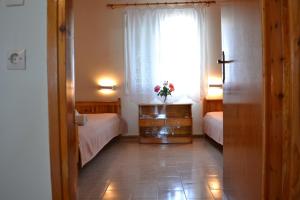 Postel nebo postele na pokoji v ubytování Dimitras House