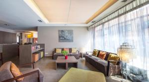 a living room with a couch and a table at Hotel Rastelli Tervuren in Tervuren