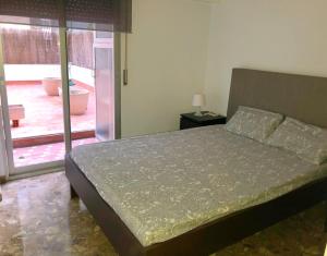 a bedroom with a bed and a door to a courtyard at El Jardín de Verónica in Zaragoza