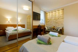 a hotel room with two beds and a mirror at CityPark Villa Flat in Budapest +47 photos