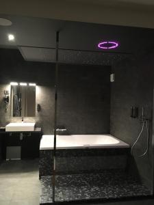 a large bathroom with a tub and two sinks at La suite Marilyn in Rouen