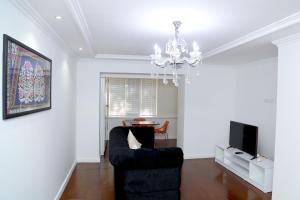 a living room with a couch and a tv at Apartment on Registon Kochasi in Samarkand +6 photos