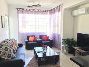 a living room with a couch and a coffee table at Vangelios Apartments in Paphos
