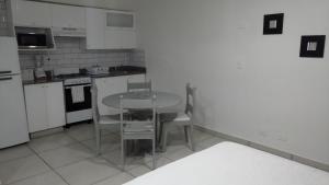 a kitchen with a table and chairs in it at Apart Hotel Turey in Santo Domingo