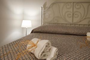 Postel nebo postele na pokoji v ubytování InGarda Rooms