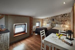 a bedroom with two beds and a table and a dining room at Loft Piotrkowska by Good Time in Łódź