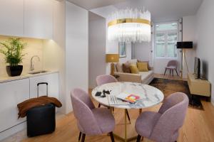 a kitchen and a living room with a table and chairs at Ouro Grand by Level Residences in Lisbon