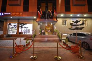 a building with a car parked in front of it at Ritan Apart-Hotel in Taif
