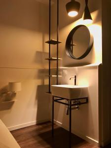 a bathroom with a sink and a mirror on the wall at Hotel Principe di Piemonte in Rimini