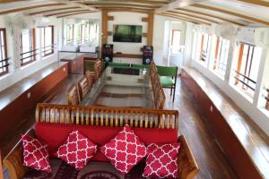 a train car with a red couch and chairs at Friends Cruise, Nightstay Houseboat in Alleppey
