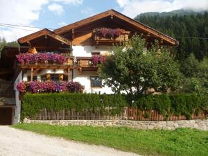 a house with flowers on the side of it at Familie Neunhäuserer in Neustift im Stubaital