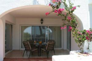 Sitio de CalahondaにあるMiraflores spacious garden house Mijas near beach IR33のピンクの花が咲くパティオ(テーブル、椅子付)