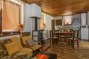 a living room with a couch and a table at Chata Alpina in Ružomberok
