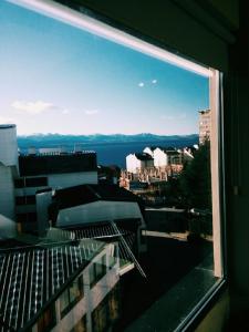 a view of a city from a window of a building at BarilocheCentro I in San Carlos de Bariloche