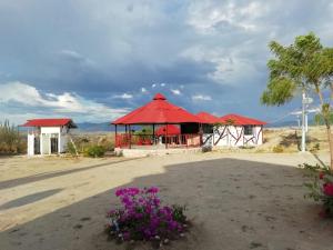 a pavilion with a red roof in the desert at Payande - Tatacoa in Villavieja