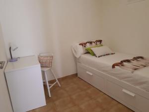 リスボンにあるCrisapartmentの小さなベッドルーム(ベッド1台、デスク付)