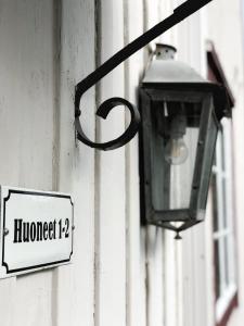 a street light on the side of a building with a sign at Hotel Palo in Naantali