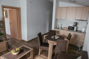 a kitchen and dining room with a table and chairs at Big Hill Apartment in Kotor