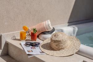 a straw hat and glasses on a table next to a swimming pool at Riad Dar Tmania in Marrakesh