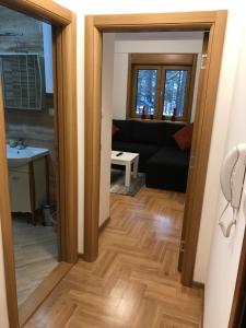 a living room with a black couch and a table at Zlatibor apartmani Jakovljevic in Zlatibor +93 photos