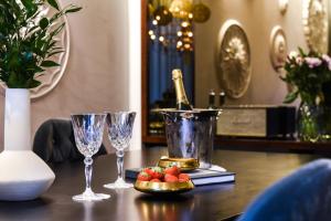 a table with wine glasses and a bottle of champagne at Elite Eden Park Hotel in Stockholm