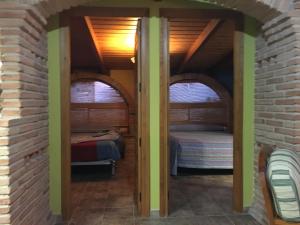 a room with two beds in a brick wall at El Mirador in Quinto