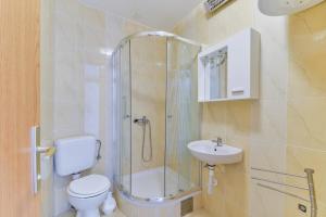 a bathroom with a shower and a toilet and a sink at Apartments Citrus in Turanj +67 photos