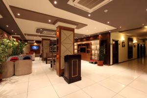 a lobby of a hotel with a tv on the wall at Taleen AlSulaimanyah hotel apartments in Riyadh