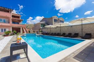 a swimming pool in the backyard of a villa at Studio Grebastica - Sibenik Riviera 7036 in Grebaštica