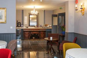 a restaurant with a bar with a table and chairs at Beckenham Park Hotel in Beckenham