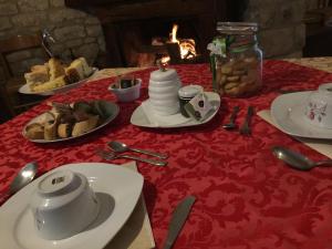 a table with plates of food on a red table cloth at Masseria Frangiosa in Torrecuso
