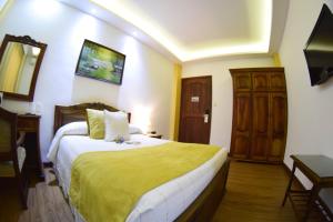 Ένα ή περισσότερα κρεβάτια σε δωμάτιο στο El Gran Hotel de Pereira