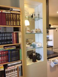 a book shelf filled with lots of books at Apartment on Spasskaya 61 in Kirov