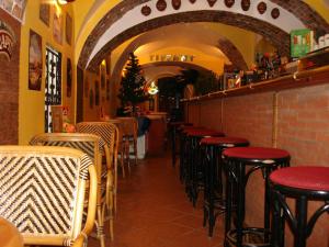 a row of tables and stools in a restaurant at Centrum Tiffany Pension in Domažlice