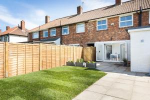 a wooden fence in front of a house at James Cook's Retreat in Middlesbrough