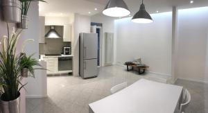 a kitchen with a refrigerator and a table at Suite i Gessi in San Ruffillo