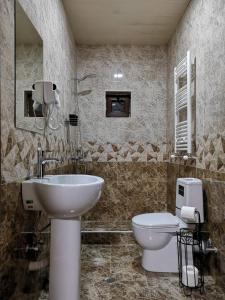 a bathroom with a sink and a toilet at UP in Stepantsminda