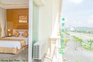 a hotel room with a bed and a view of a beach at Palm Hotel Thanh Hoa in Thanh Hóa +46 photos