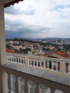 a view of a city from the balcony of a building at Hospedagem Narcizo in São Lourenço